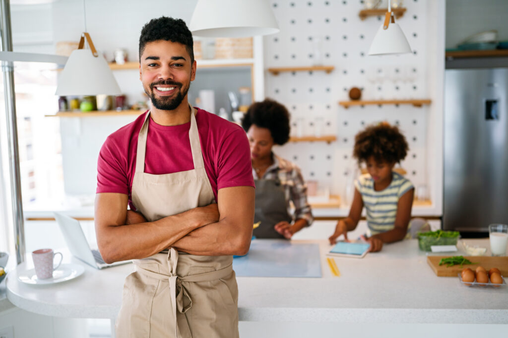 small business owner standing in front of his counter
